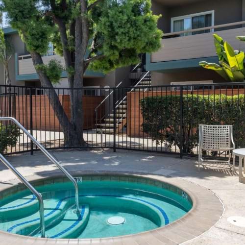 a hot tub in a fenced-in area