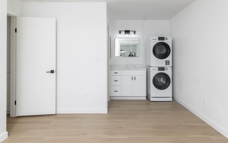 a room with white cabinets and a washing machine