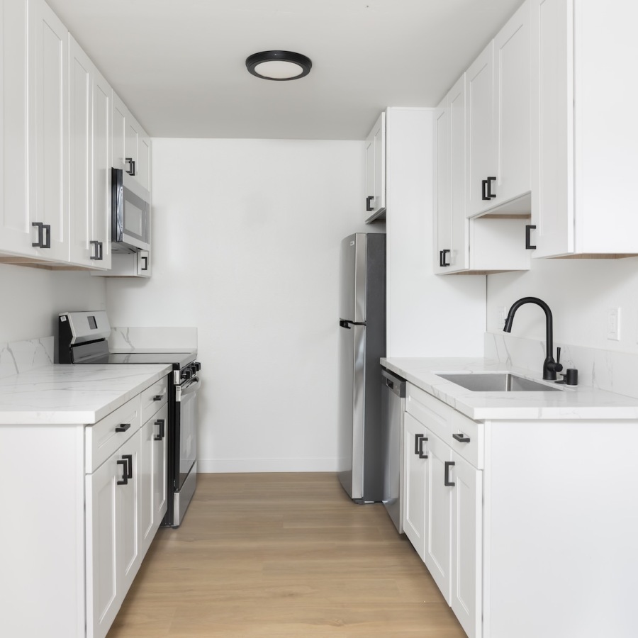 a kitchen with white cabinets
