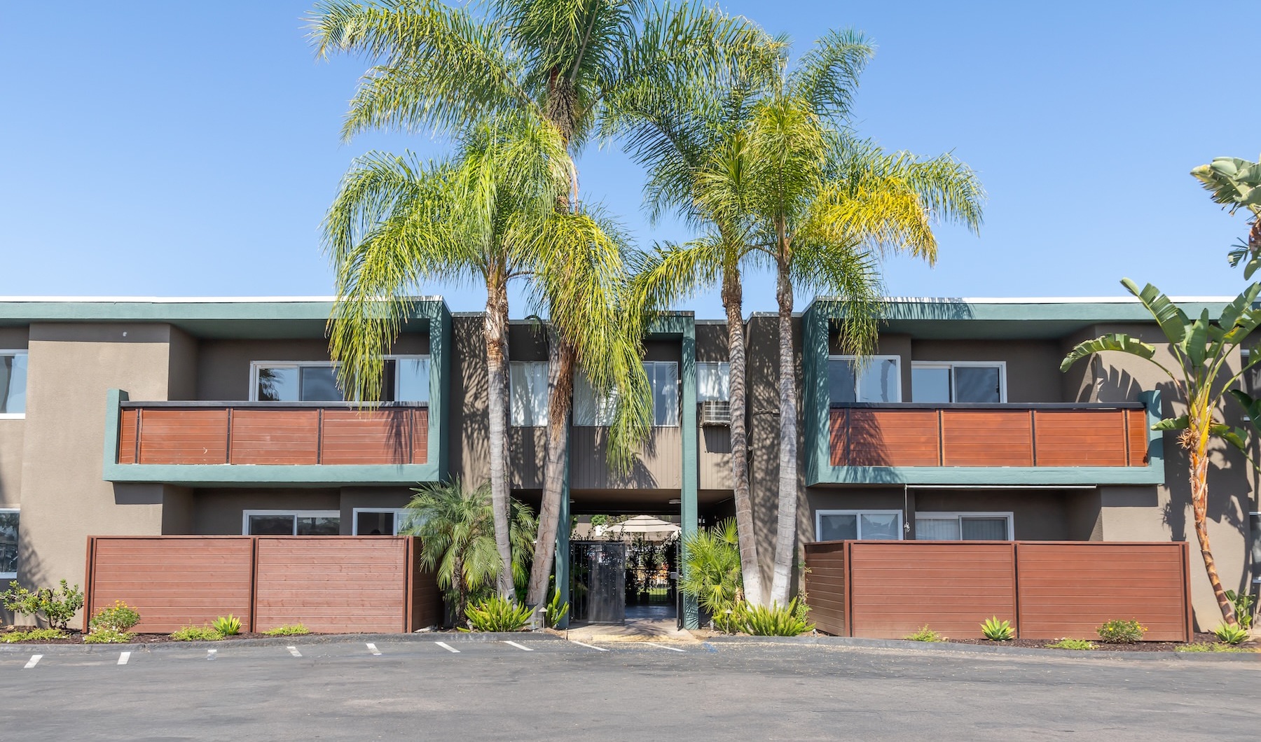an apartment building with palm trees