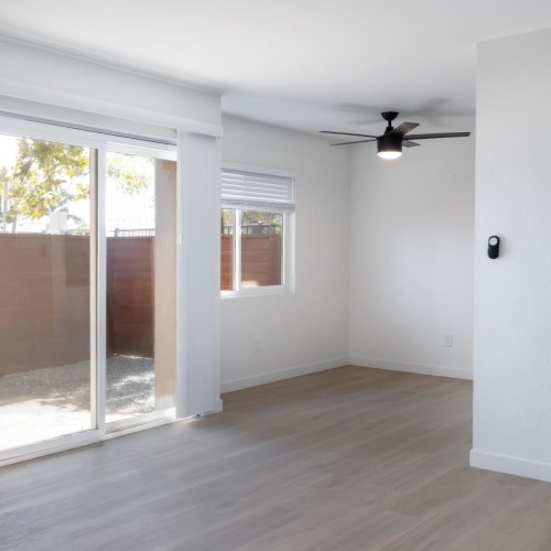 a room with a wood floor and a wood floor with a white door